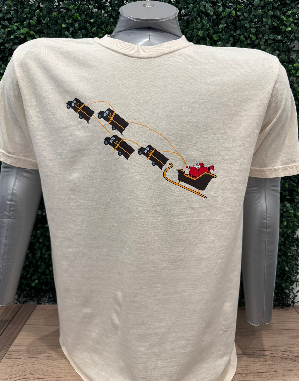 UPS Santa Peak Season Christmas Tee featuring Santa pulled by UPS trucks graphic on soft cotton shirt