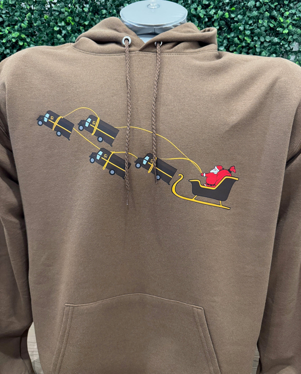 Brown UPS Santa Christmas hoodie with Santa sleigh pulled by UPS trucks graphic
